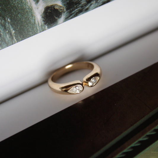 Gold ring with two pear shape diamonds
